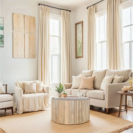 Hudson Carved Mango Wood Round Coffee Table in bright living room with beige decor and natural light
